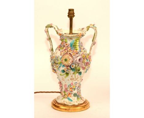 A 19th century porcelain vase lamp by Rockingham, circa 1855, with flower encrusted decoration, raised on giltwood base, 39cm