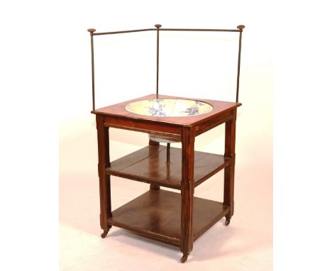 A corner washstand circa 1900, with metal gallery rail, raised on shelved base with blue and white pottery basin insert, 127c