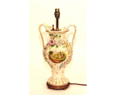 A 19th century Rockingham porcelain vase lamp, circa 1860, with flower encrusted decoration and painted with view of an Abbey