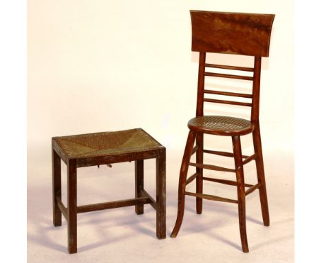 A stained beech child's correction chair, circa 1830, with caned seat, 98cm high x 29cm wide, together with a rush seated sto