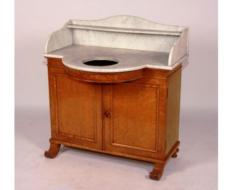 A Victorian maplewood wash stand, circa mid 19th century, the shaped white marble top with basin recess above two panelled do