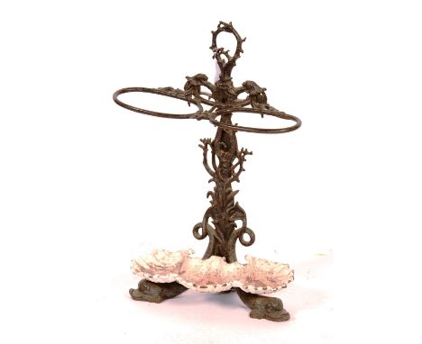 A Victorian iron stick stand circa 1870, with marine motifs (coral and seaweed, supported on Dolphin feet, with a shell shape