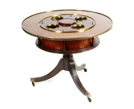 A mahogany drinks table, circa early part of 19th century, with later top, of circular form with four bottle receivers, raise