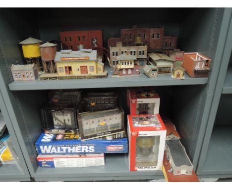 Two shelves of Walthers, Bachmann and similar HO scale kits and accessories some boxed