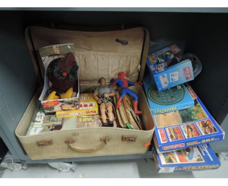 A shelf of vintage Giles books, a modern action man and a selection of games etc