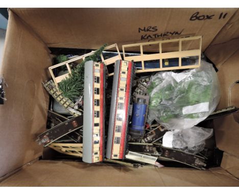 A box of Hornby Dublo three rail track and accessories including signals, buffer stops and two carriages along with a Hornby 