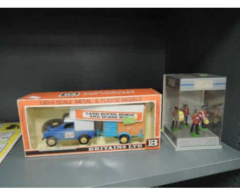 A Britains 1:32 scale metal and plastic model, Land Rover and Horse Box, in original box 9573 and a Britains lead four figure