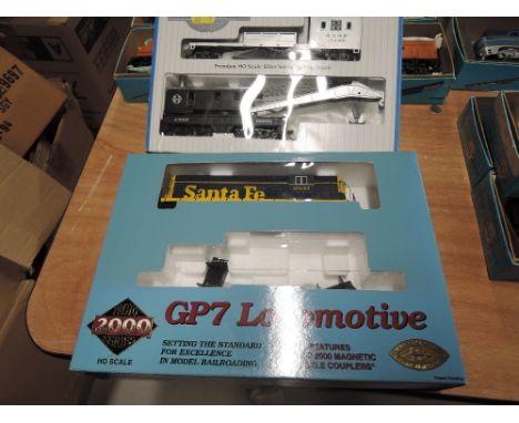 A Proto 2000 series HO scale GP7 locomotive, Santa Fe, boxed 23170 and a Bachmann HO scale 250 ton crane cars and boom tender