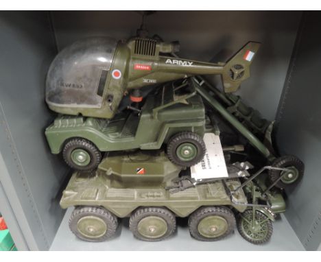 A shelf of Action Man style plastic vehicles including Cherilea Toys Saladin mk11 Armoured Car with instructions leaflet, sim