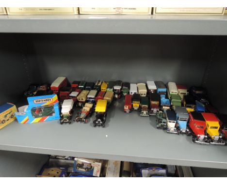 A shelf of Matchbox Models of Yesteryear and similar diecasts, two with boxes 