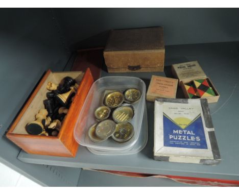 A selection of vintage games including treen chess pieces, brass ball puzzles, Chad Valley metal puzzles etcCONDITION REPORT 