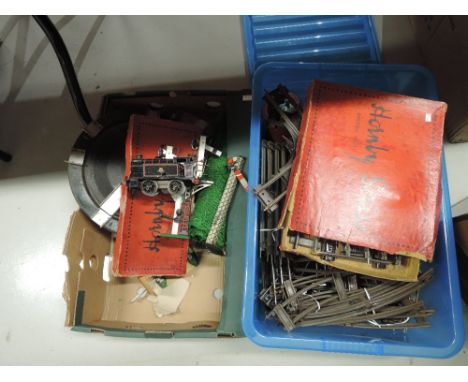 Two boxes of Hornby and similar 0 gauge including clockwork 0-4-0 tank engine, points, track and signals