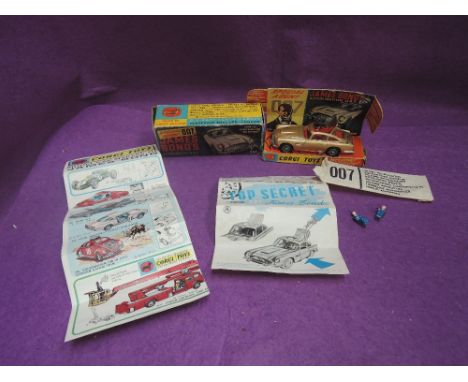 A Corgi diecast, James Bond Aston Martin DB5 with driver and two bandits on inner card display stand, with secret instruction