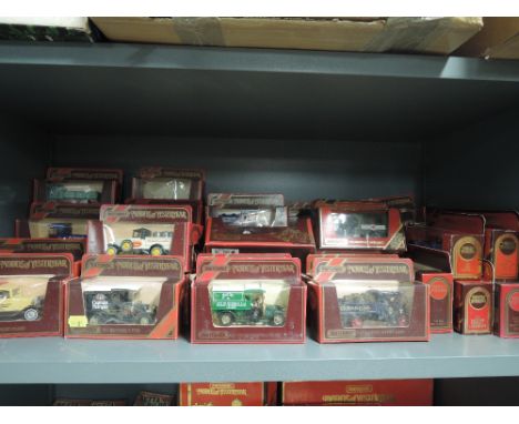 A shelf of Matchbox Models of Yesteryear diecasts all in red window boxes, approx 60