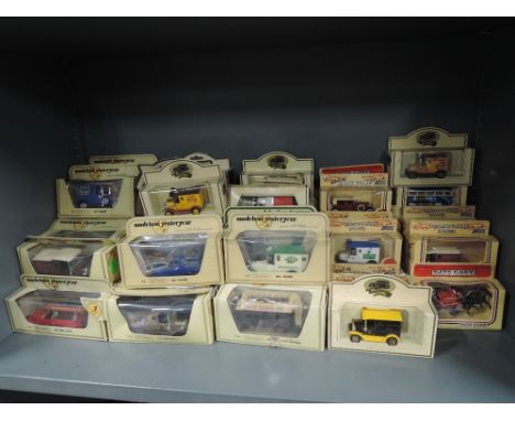 A shelf of Matchbox Models of Yesteryear and Days Gone diecasts, approx 60, all in straw window boxes