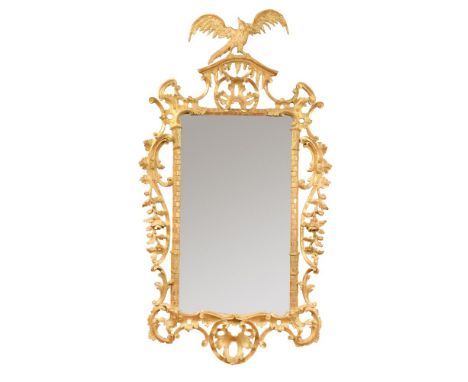 An 18th century Chippendale style carved giltwood mirror, with carved spreading-wing bird crest and open rococo scroll border