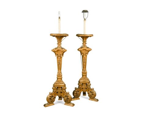 A pair of late 19th century Louis XIV style giltwood torcheres, each surmounted by circular tray tops, fitted as standard lam