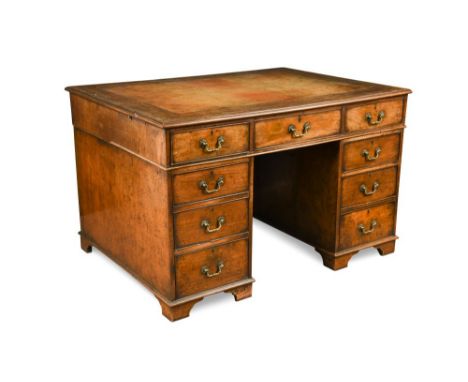 A George III mahogany pedestal partners desk, with a gilt tooled brown leather lined top, with nine drawers around a kneehole