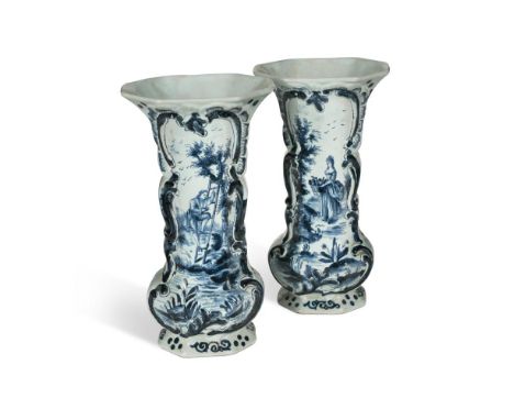 A pair of Dutch Delft blue and white vases, 19th century, one painted with a gentleman climbing a ladder, the other with a la