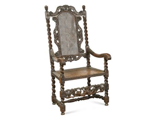 A late 17th century walnut framed armchair, with carved crest rail, cane panel back and seat 123 x 62 x 59cm (48 x 24 x 23in)