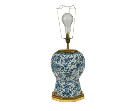 An 18th century Dutch Delft blue &amp; white vase, now fitted as a table lamp, painted with an all over pattern of flowering 