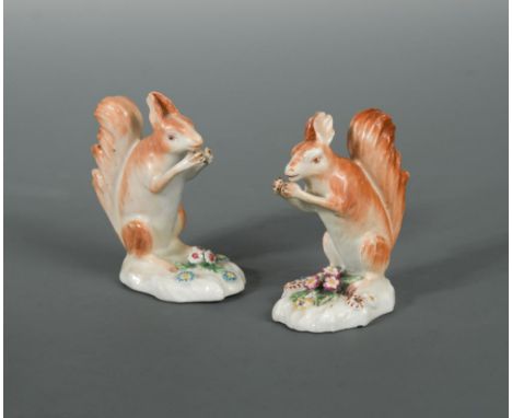 A rare pair of Derby Patch Mark models of red squirrels, circa 1765-70, naturalistically modelled on floral encrusted bases, 