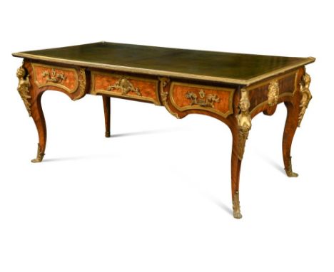 A mid 19th century Louis XV style French ormolu mounted kingwood, tulipwood and parquetry inlaid bureau plat, the top inset w