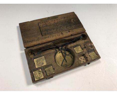 A walnut cased coin balance scale, German, 18th century, stamped with various coin denominations, most weights present, also 