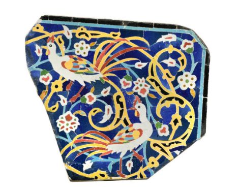 An Islamic Persian Safavid style pottery panel, probably 19th century depicting two fanciful birds amongst scrollwork, within