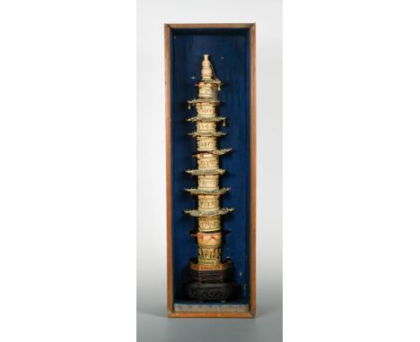 A Chinese carved and polychrome painted ivory nine storey pagoda, early Republic, each cylindrical section carved in high rel