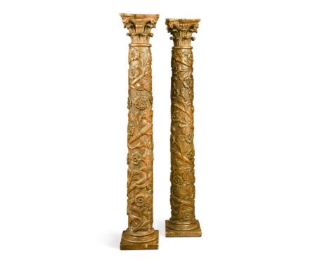 A pair of 18th century Italian carved giltwood column alter candlestick bases, each carved in relief with scrolling foliage a