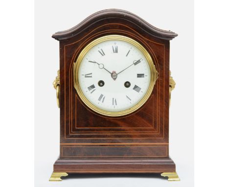 An Edwardian inlaid mahogany mantle arch topped mantle fusee mantle clock, with twin lion mask swing handles, the white dial 