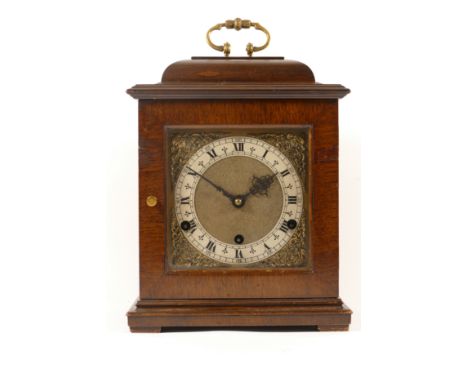 A 20th century mahogany cased mantle clock, the glass door opening to reveal brass dial, the brushed dial with black Roman nu