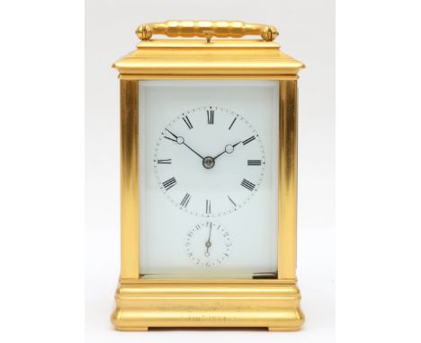 A late 19th century brass corniche cased and four glass presentation striking carriage clock, with swing handle, the white di
