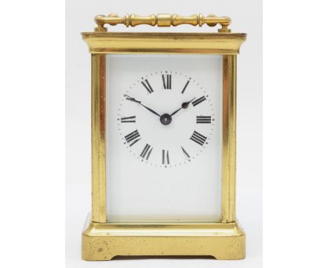 A 20th century corniche brass cased and four glass carriage clock, with swing handle the white dial with black Roman numerals