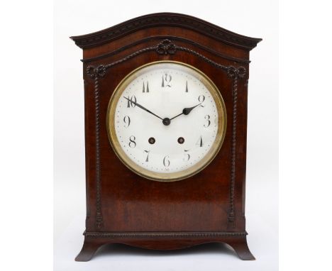 A late 19th century mahogany veneered cased mantle clock, with carved rope twist style decoration, the domed top cornice with