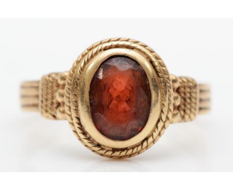 A vintage 9ct gold garnet dress ring, with rope twist and bead decoration, O, 3gm. 