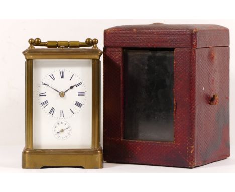 An early 20th century brass corniche cased and four glass carriage clock, with swing handle, the white dial with black painte