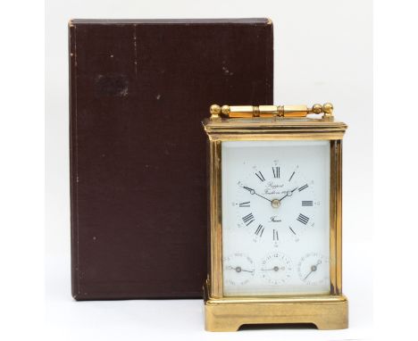 An early 20th century Rapport brass corniche cased and four glass repeating striking carriage clock, with swing handle, the w