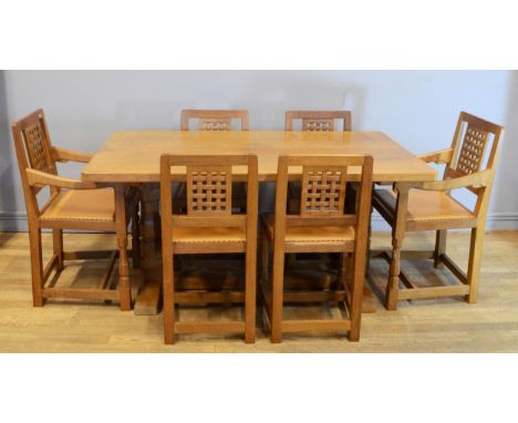 Robert 'Mouseman' Thompson of Kilburn, a adzed oak dining table raised on octagonal supports and trestle style base, c1980s, 