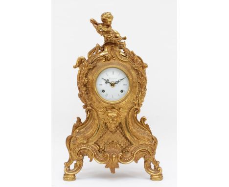 Imperial, a 20th century gilt brass cartouche shaped mantle clock, cast with putti finial and acanthus leaf, the head of Bacc