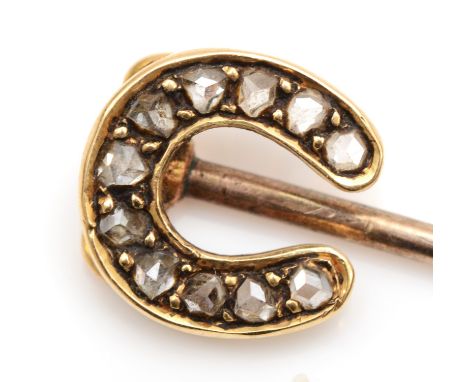 A Victorian unmarked gold horse shoe stick pin, set with mine cut diamonds, 5cm, 1.2gm.Size of head 9 x 9mm