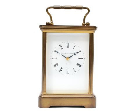 Matthew Norman of London, a 20th century brass corniche and four bevelled glass carriage clock, with swing handle, the white 