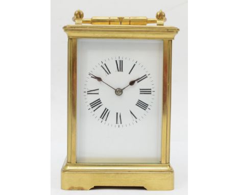 A late 19th/early 20th century French brass corniche cased repeating mantle clock, the white dial with black painted Roman nu