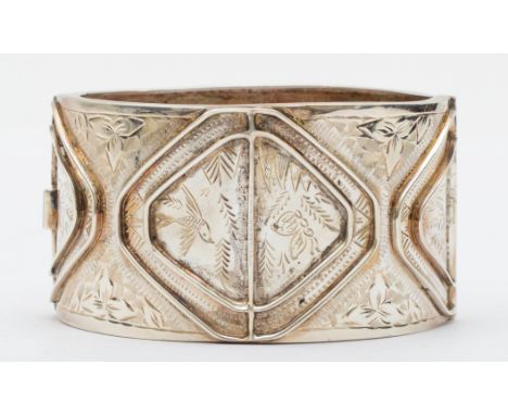 A vintage silver cuff bangle, Birmingham 1994, with chased foliate, bird and insect decoration, 59mm, 42gm. 
