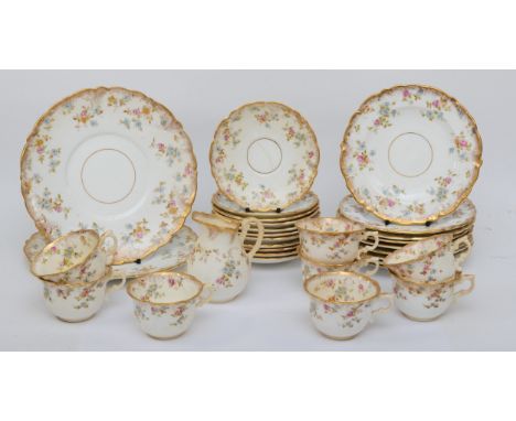 A 19th century gilt and hand painted floral teaset comprising of ten 10cm saucers, eight cups, nine 18.5cm plates, two 23cm p