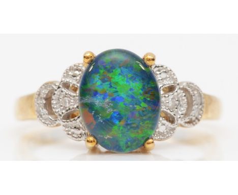 A 9ct black opal triplet dress ring, with eight cut diamonds set to the shoulders, Q, 3gm. 