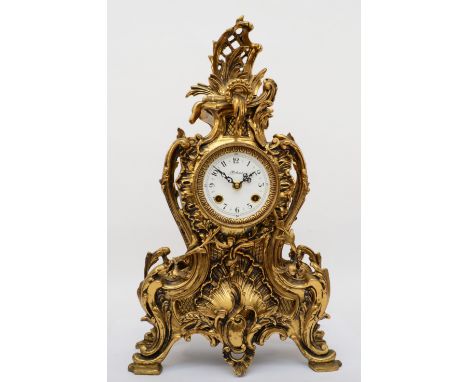 Korslant, a late 19th/early 20th century gilt brass cartouche shaped mantle clock, the white painted dial signed and black Ar