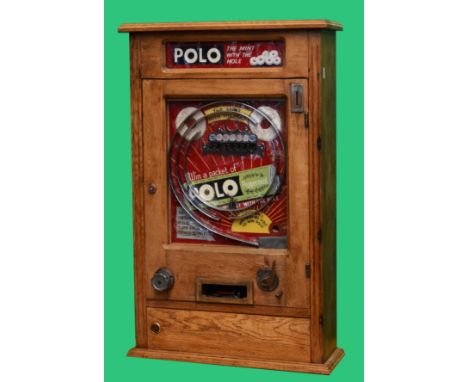 Polo Allwin, by Oliver Whales, c.1954, oak cased slot machine, plays 1d, 51 x 18 x 82cm. Key for cabinet