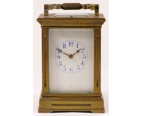 An early 20th century French brass and four glass corniche cased striking carriage clock, with swing handle, the white dial w